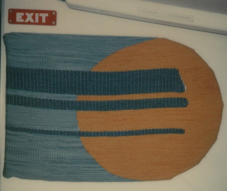 May 1979 economy class bulkhead artwork.  This fabric artwork appeared on the right side bulkhead  behind first class at the front of the economy cabin.